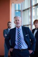 senior business man with his team at office photo