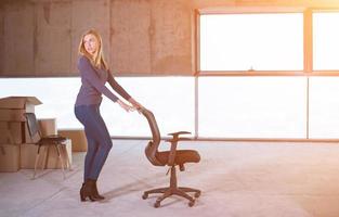 business woman pushing office chair photo