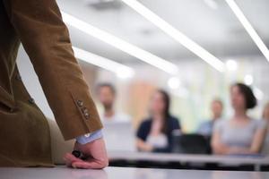 close up of teacher hand while teaching in classroom photo