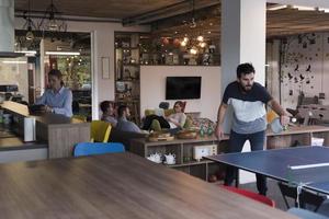 playing ping pong tennis at creative office space photo