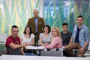 portrait of  teacher with students group in background photo