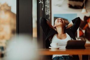 a latino woman sitting in a cafe on a break from work photo