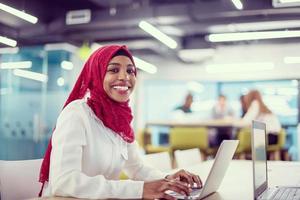black muslim business woman ,working on laptop computer photo