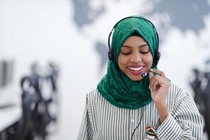 African muslim female with phone headset helping and supporting online photo