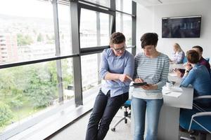 Two Business People Working With Tablet in office photo