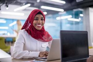 black muslim business woman ,working on laptop computer photo