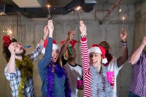 multiethnic group of casual business people dancing with sparklers photo