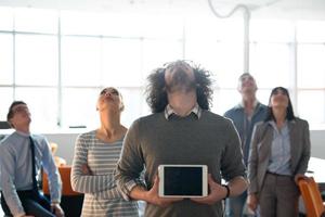 Portrait of a young businessman holding tablet photo