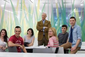 portrait of  teacher with students group in background photo