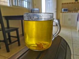 Glass or cup pot with hot ginger tea. photo