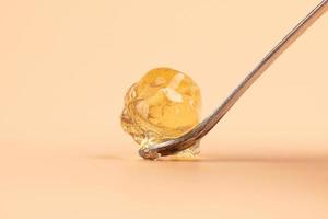 yellow wax with dabbing stick of cannabis resin for smoking high in THC photo