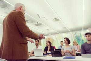 teacher with a group of students in classroom photo