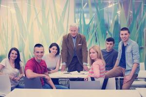 portrait of  teacher with students group in background photo