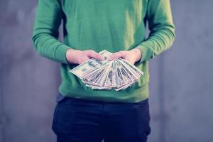 business man displaying a spread of american dollar cash money photo