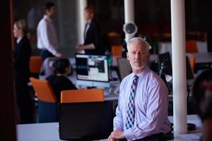 senior business man with his team at office photo