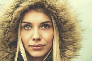portrait of young blonde girl wearing winter jacket photo