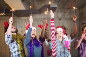 multiethnic group of casual business people dancing with sparklers photo