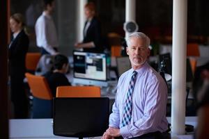 senior business man with his team at office photo