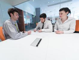 young couple signing contract documents on partners back photo