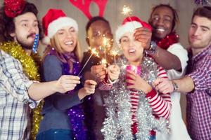 multiethnic group of casual business people lighting a sparkler photo