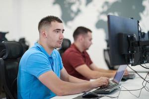 two male software developers working on computer photo
