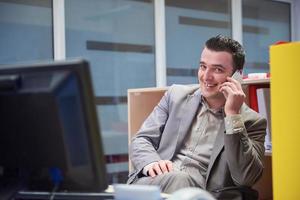 hombre de negocios hablando por teléfono en la oficina foto