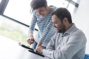 Two Business People Working With Tablet in startup office photo