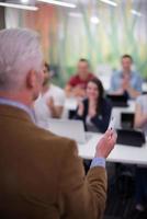 teacher with a group of students in classroom photo