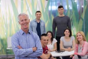 portrait of  teacher with students group in background photo