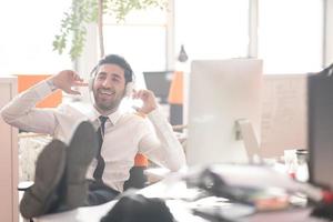 relaxed young business man at office photo