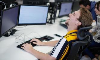 casual business man working on desktop computer photo