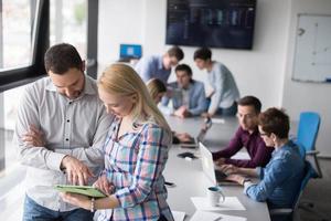 Two Business People Working With Tablet in office photo