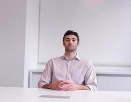 young business man portrait  at modern office photo