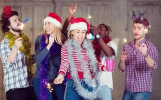 multiethnic group of casual business people dancing with sparklers photo