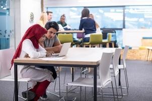 black muslim business woman having a meeting with her indian male colleague photo