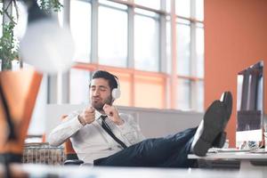 relaxed young business man at office photo