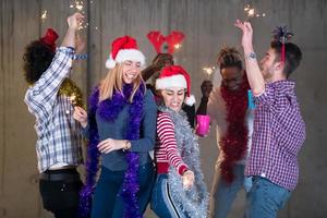 multiethnic group of casual business people dancing with sparklers photo