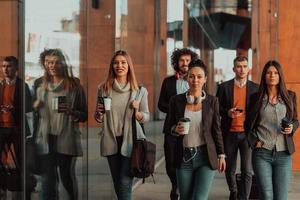 Business colleagues walking and talking on city streets photo