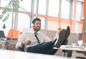 relaxed young business man at office photo