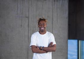 portrait of black businessman in front of a concrete wall photo