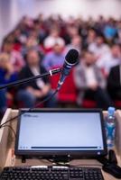 laptop computer and microphone at podium photo