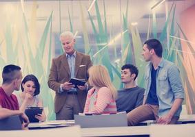 teacher with a group of students in classroom photo