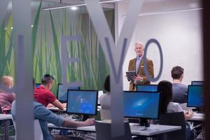 teacher and students in computer lab classroom photo