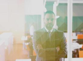 young business man portrait  at modern office photo