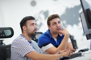 two male software developers working on computer photo