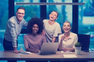 Multiethnic startup business team in night office photo