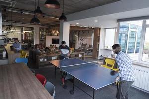 playing ping pong tennis at creative office space photo