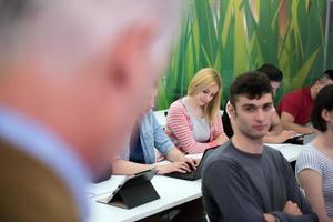 teacher with a group of students in classroom photo