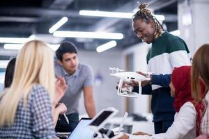 multiethnic business team learning about drone technology photo