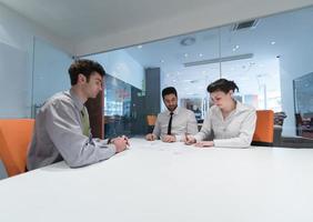 young couple signing contract documents on partners back photo